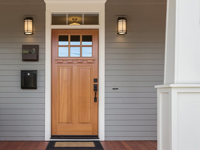 Wood front door with 6 small windows at the top. 